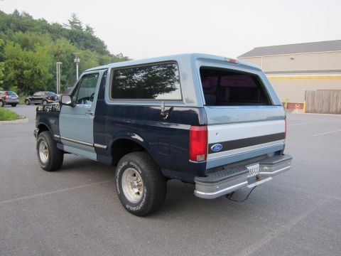 2001 Ford Crown Victoria - This two-tone blue Ford Bronco is parked in a lot, viewed from the rear 3/4 angle.
