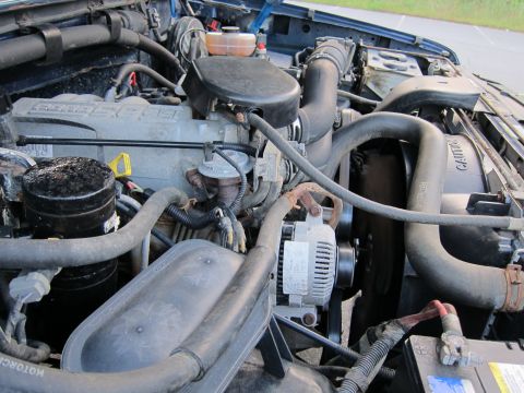 2001 Ford Crown Victoria - Close-up view of a vehicle's engine bay, showing various components and wiring.