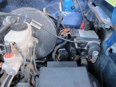 2001 Ford Crown Victoria - Close-up view of engine bay components including the brake booster and master cylinder.