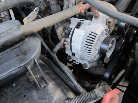 2001 Ford Crown Victoria - The alternator and surrounding engine parts are covered in dust and grime.