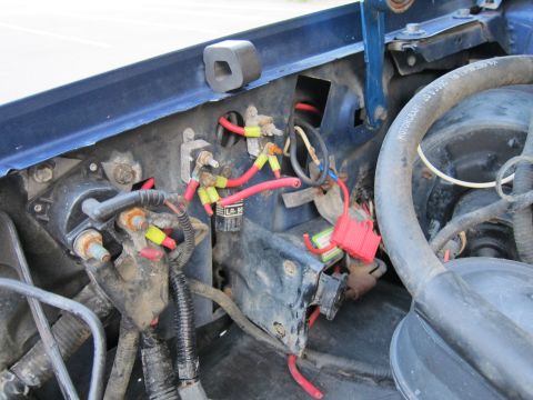 2001 Ford Crown Victoria - Close-up view of the engine bay wiring and components, including a Motorcraft hose and various electrical connectors.
