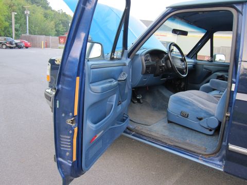 2001 Ford Crown Victoria - Interior view of a blue pickup truck, showing the driver's seat, dashboard, and door panel.