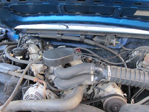 2001 Ford Crown Victoria - Close-up view of an engine bay, showing various mechanical parts and connections.