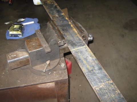 1972 Ford F-250 - A metal bar is secured in a vise, ready for work, with tools on a blue cloth.