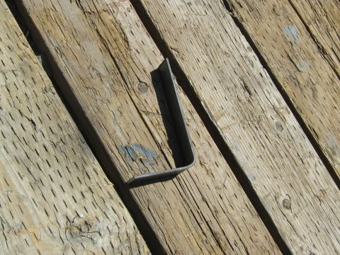 1972 Ford F-250 - Metal bracket on weathered wooden planks.