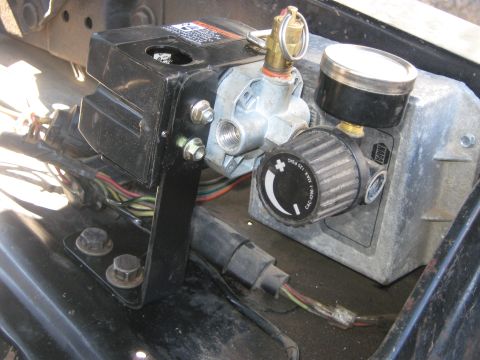 1972 Ford F-250 - Close-up of an air compressor regulator assembly, showing its various components and wiring.