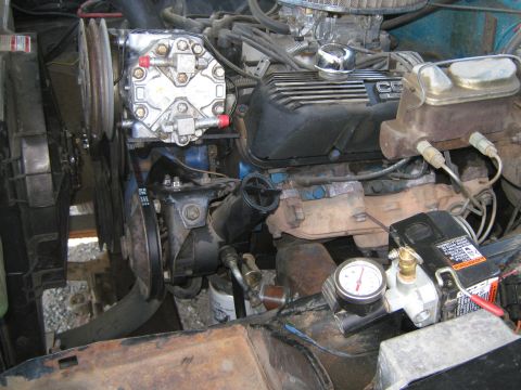 1972 Ford F-250 - The engine bay features an air conditioning compressor and a separate air compressor unit with a pressure gauge.