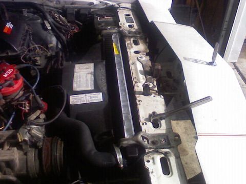 1987 Mercury Grand Marquis - Close-up view of a vehicle's engine bay, showing various components and wiring.