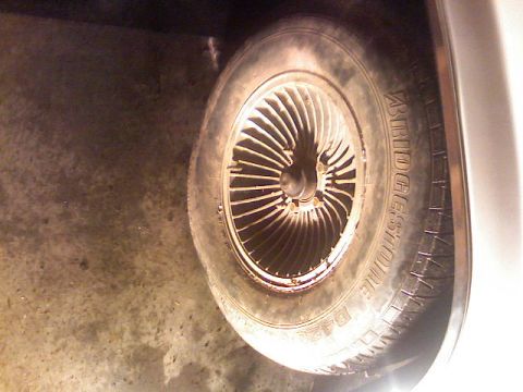 1987 Mercury Grand Marquis - A close-up view of a tire and wheel assembly, showing the Bridgestone brand on the tire.