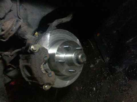 1987 Mercury Grand Marquis - Close-up of a brake rotor and caliper assembly, likely from a 1987 Mercury Grand Marquis.