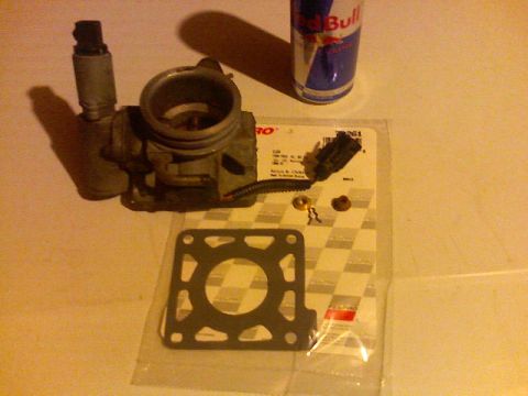 1987 Mercury Grand Marquis - Throttle body and gasket kit, with a Red Bull can in the background.