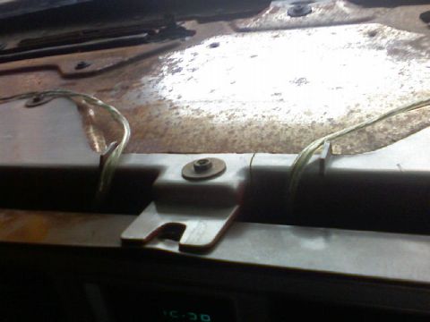 1987 Mercury Grand Marquis - Close-up of the dashboard interior of a 1987 Mercury Grand Marquis, revealing exposed wiring and signs of rust.