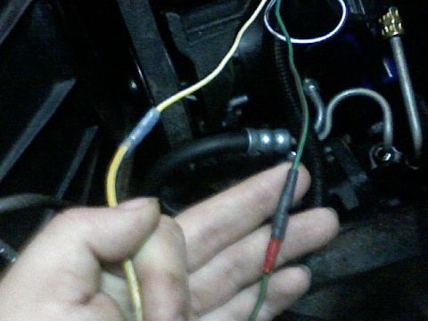 1987 Mercury Grand Marquis - Close-up of a hand manipulating electrical wires and connectors within a dark, mechanical space.