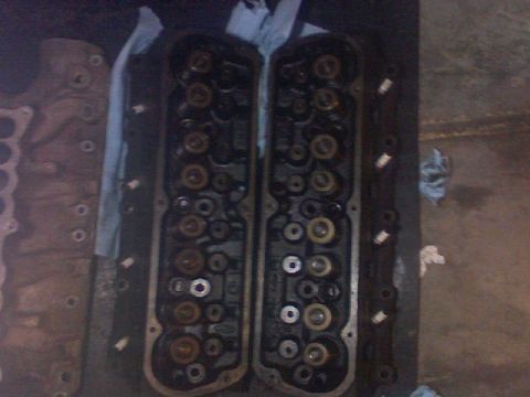 1987 Mercury Grand Marquis - Close-up view of two engine cylinder heads, showing the internal valve mechanisms.