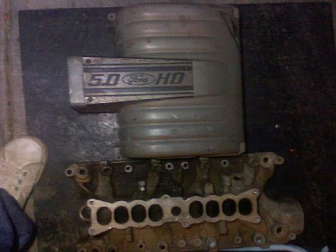1987 Mercury Grand Marquis - A Ford 5.0 HO intake manifold is shown with engine components below.