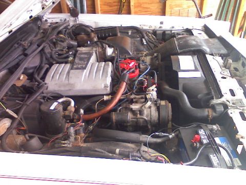 1987 Mercury Grand Marquis - Engine bay of a vehicle, showing the V8 engine components and battery.