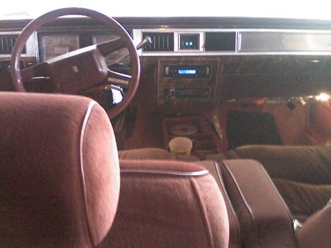 1987 Mercury Grand Marquis - The interior of a car is shown, a steering wheel, dashboard, and seats.