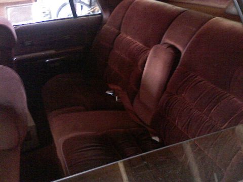 1987 Mercury Grand Marquis - Maroon velvet seats and door panel visible inside a 1987 Mercury Grand Marquis.