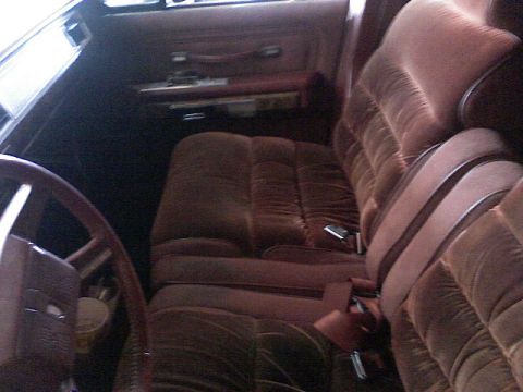 1987 Mercury Grand Marquis - The plush interior of a 1987 Mercury Grand Marquis, comfortable brown velour seats and a classic steering wheel.