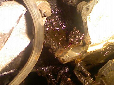1987 Mercury Grand Marquis - Visible oil leak and grime on engine parts, indicating maintenance needs.