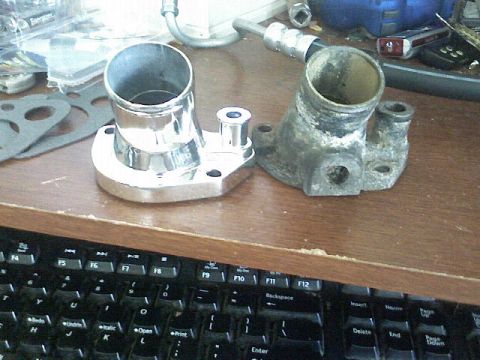 1987 Mercury Grand Marquis - A comparison between a new, shiny thermostat housing and an old, worn-out one.