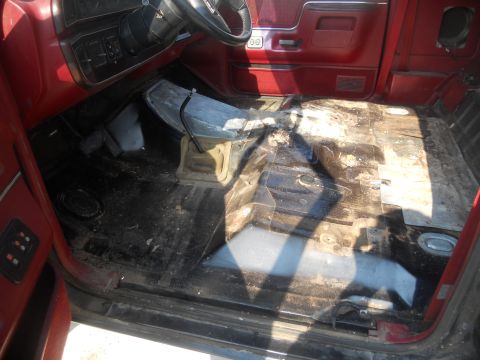 1991 Ford Bronco - The interior of a 1991 Ford Bronco shows red trim and a floor in need of cleaning.