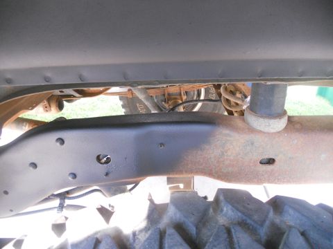 1991 Ford Bronco - Close-up view of the undercarriage of a vehicle, showing frame components and suspension.