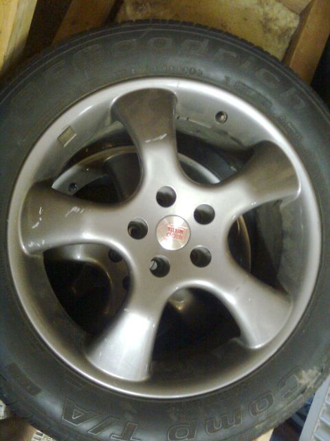 1984 Ford Bronco - Close-up of an aftermarket wheel and tire assembly with visible text on the tire sidewall.