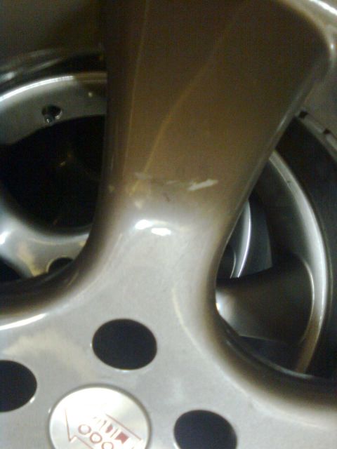 1984 Ford Bronco - A close-up shot focuses on a car wheel, revealing a 'Vette' emblem and part of the tire.