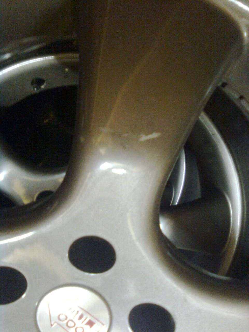 Close-up of a car wheel with a logo that says 'Vette' and '000'