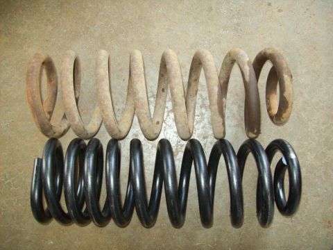 1993 Ford F-150 - Comparison of a used, rusty coil spring and a new, black coil spring.