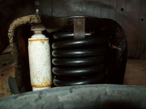 1993 Ford F-150 - A close-up view of a vehicle's suspension system, showing a coil spring and shock absorber.