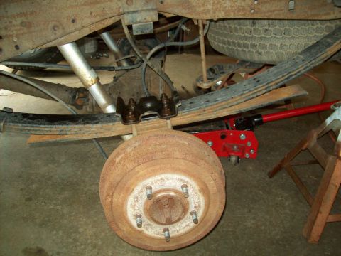 1993 Ford F-150 - Close-up of a truck's rear suspension and braking system, showing significant rust.