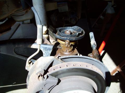 1993 Ford F-150 - Front suspension part detail, showing brake rotor and shock mount.