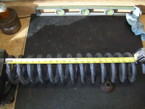 1993 Ford F-150 - A suspension coil spring is measured with a tape measure, showing its length.