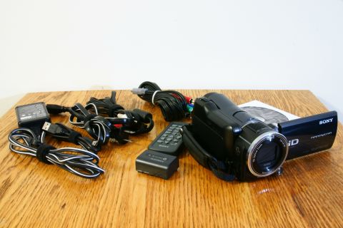 1993 Ford Taurus - A Sony Handycam camcorder and its accessories are laid out on a wooden surface.