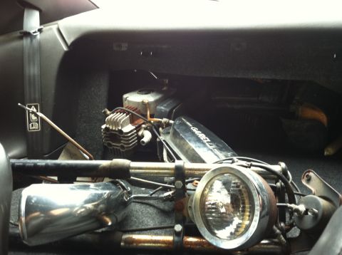 1981 Garelli Rally Sport - Close-up of a Garelli engine and headlight, possibly stored in a vehicle's cargo area.