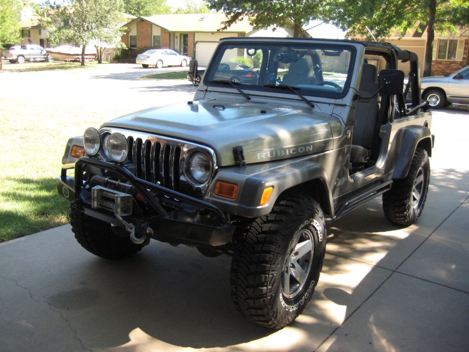 Silver 2005 Jeep Wrangler Rubicon with winch and aftermarket wheels