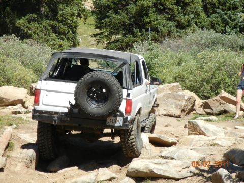 1996 Ford Bronco - This 1996 Ford Bronco is navigating a challenging rocky trail, its off-road capabilities.