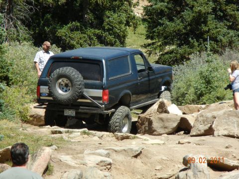 1996 Ford Bronco - A 1996 Ford Bronco tackles a challenging off-road course, demonstrating its capability on rough terrain.