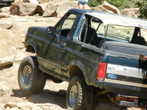 1996 Ford Bronco - This 1996 Ford Bronco is navigating a rocky trail, demonstrating its off-road capabilities.