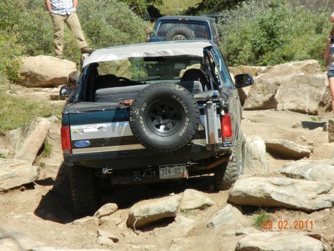 1996 Ford Bronco - 1996 Ford Bronco tackling a challenging rocky trail with another vehicle following.