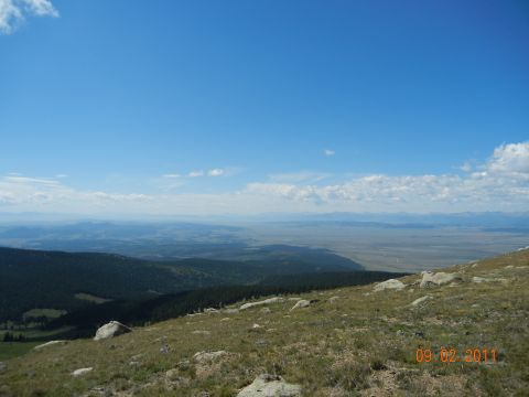 1996 Ford Bronco - Expansive view from a mountain overlook, showing distant plains under a blue sky with clouds.