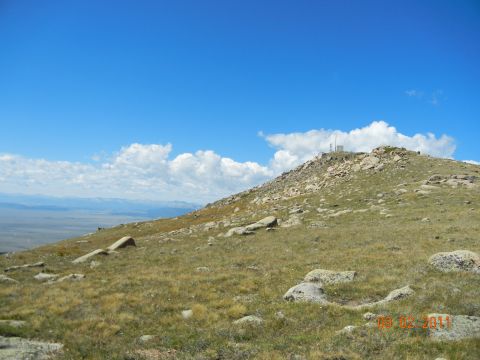 1996 Ford Bronco - Mountain landscape with radio tower on summit under blue sky with clouds. Date stamp reads 08-02-2011.