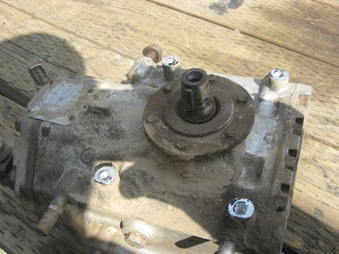 1972 Ford F-250 - Close-up of a transfer case, likely for a truck, on a wooden surface.