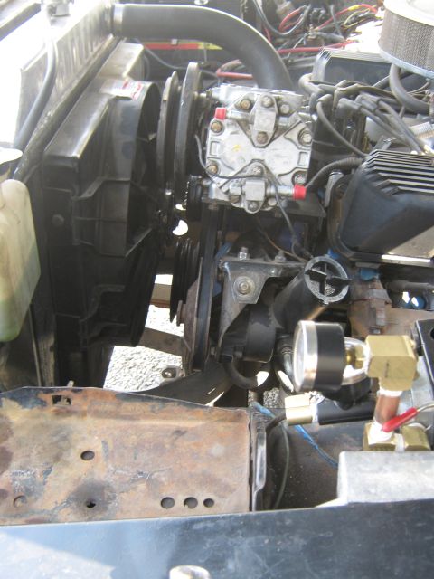 1972 Ford F-250 - Engine compartment view with a serpentine accessory drive, A/C compressor, pressure gauge and brass plumbing fittings during a build.