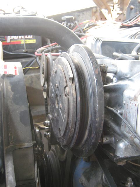 1972 Ford F-250 - Close-up view of the engine's pulley system, showing the belts and clutch mechanism.