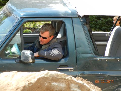 1996 Ford Bronco - A man drives an off-road vehicle through a rocky terrain, with a date stamp visible in the corner.