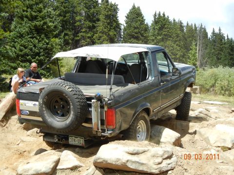 1996 Ford Bronco - This Ford Bronco is tackling a challenging off-road course with large rocks.
