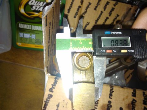 1995 Ford Probe - A digital caliper is used to measure a metal component, likely for an automotive repair or build.